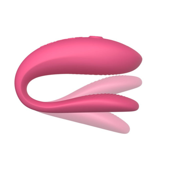 The We-Vibe Sync Lite App Controlled Wearable Couples Vibrator - Pink by We-Vibe showcases a sleek, curved design with dual arms crafted for both internal and external stimulation. The flexible device features a smooth texture, ensuring comfortable use. The product image displays a side view against a plain white background.