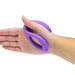 A person holds the We-Vibe Sync O Hands-Free Wearable Couples Vibrator - Purple, an ergonomically designed, oval-shaped object with a hollow center that fits around the wrist. The flexible and smooth device fits comfortably in the hand and is waterproof. This innovative couples vibe by We-Vibe can be app-controlled for an enhanced experience.