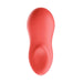 The We-Vibe Touch X Lay On Vibrator in Coral is a sleek and seamless, USB rechargeable personal massager designed for handheld use. Crafted from premium silicone, it features a red color with a smooth, ergonomically shaped design that includes a rounded top and curved contour.