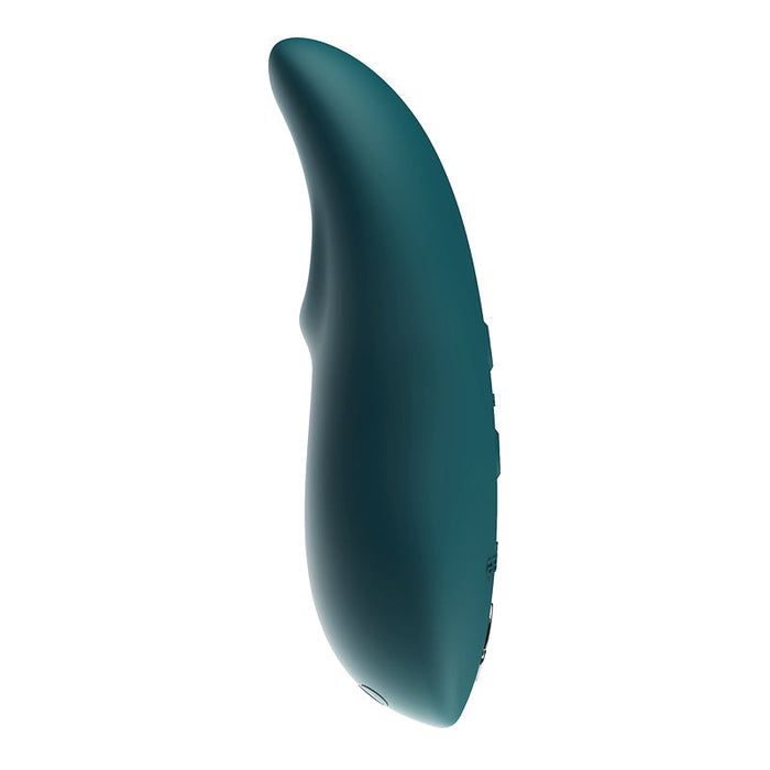 The We-Vibe Touch X Lay On Vibrator by We-Vibe is a dark green, sleek, and curved handheld device with buttons along its side. Designed ergonomically for comfort and ease of use, it's coated in smooth silicone for a comfortable grip. This waterproof vibrator also features a slight indentation to enhance its user-friendly design.