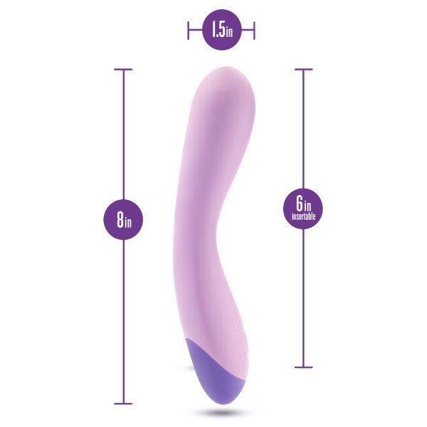 Introducing the Wellness G Curve Rumbly Waterproof Silicone G-Spot Vibrator by Blush—a lavender-colored vibrator specially designed with a slight curve. Crafted from silky silicone, it measures 8 inches in total length, with a 6-inch insertable length and a diameter of 1.5 inches at its widest point. Perfect for G-spot exploration, its base is adorned in a darker purple shade.

