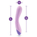 Introducing the Wellness G Curve Rumbly Waterproof Silicone G-Spot Vibrator by Blush—a lavender-colored vibrator specially designed with a slight curve. Crafted from silky silicone, it measures 8 inches in total length, with a 6-inch insertable length and a diameter of 1.5 inches at its widest point. Perfect for G-spot exploration, its base is adorned in a darker purple shade.

