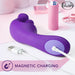 A purple Wellness G Wave Waterproof Rabbit Vibrator with an ergonomic handle from Blush is charging via a magnetic USB cable, set against a backdrop of pink lipstick and makeup brushes. The image features the "Blush" logo along with a label stating "MAGNETIC CHARGING." This ergonomically designed massager is perfect for clit and g-spot stimulation and is also waterproof.