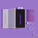 The Wellness Power Bullet - Rumbly Waterproof Ultra Strong Vibrator by Blush, in purple, rests in black foam inside an open white box. To the right, a small purple booklet labeled "Wellness" and a white charging cable are visible. The background is a matching shade of purple. This sleek and waterproof sex toy promises a powerful vibration experience for personal wellness.