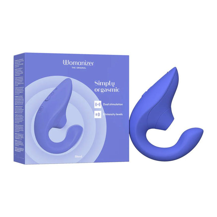 A photo of a blue Womanizer Blend Pleasure Air Clitoral & G-Spot Rabbit vibrator beside its product box. The box features the brand name "Womanizer" and the tagline "Simply orgasmic." It highlights features like dual stimulation and 8 intensity levels. The vibrator has a curved, ergonomic design.