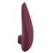 A Bordeaux-colored, sleekly designed personal massager, the waterproof Womanizer Classic 2 Pleasure Air Clitoral Stimulator. The device features a smooth, curved shape with a small protruding nozzle at the front for clitoral air pulsation and subtle control buttons on the side.