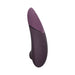 A sleek handheld electronic device in plum, the Womanizer Next Pleasure Air Clitoral Vibrator by Womanizer features an ergonomic design with three buttons on the front and a curved shape for comfortable use. Its Pleasure Air Technology ensures optimal performance, while its modern and discreet appearance adds to its appeal.