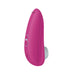 The Womanizer Starlet 3 Pleasure Air Clitoral Stimulator in pink, by Womanizer, is a sleek and curved handheld electronic device. It features two control buttons and a small circular pad at the bottom. Utilizing advanced air pulsation technology, this compact stimulator is specifically designed for personal care.