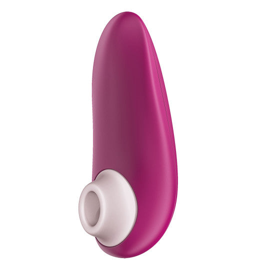 A close-up of a sleek, pink, and white Womanizer Starlet 3 Pleasure Air Clitoral Stimulator by Womanizer showcases its curved, smooth design with a round opening at one end. This compact, ergonomically shaped clitoral stimulator employs air pulsation technology to enhance pleasure.