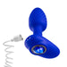 The Blush Mystery Vibrating Textured Silicone Butt Plug in Sapphire is a curved, blue device featuring a textured surface made of platinum cured silicone and a jewel-like blue button on one end. It connects to a white, coiled power cord through a port.