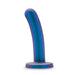 The Surrender Intermediate 5.75 Inch Silicone Beginner & Pegging Dildo by Blush, featuring a curved shape and a flat base, stands upright against a white background. Its blue and purple smooth shaft makes it an excellent choice for those exploring pegging or anal play.