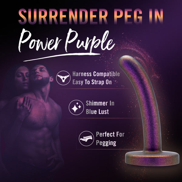 Promotional image for the Surrender Slim 4.75 Inch Silicone Beginner & Pegging Dildo by Blush. Text highlights features: "Harness Compatible, Easy to Strap On," "Shimmer in Blue Lust," and "Perfect for Pegging." Ideal for adventurous dildo play, the background shows a couple embracing.