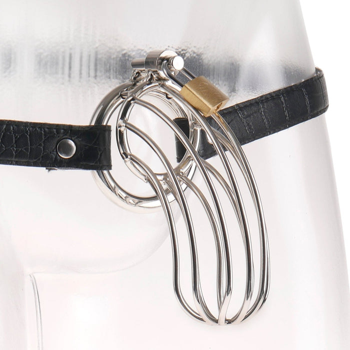 The Prisoner Extreme Locking Steel Chastity Cage by Pipedream Products is a sleek and minimalist steel cock cage with interlocking rings, securely fastened to a clear mannequin's waist using an alligator-style waist strap that features a small padlock for closure.