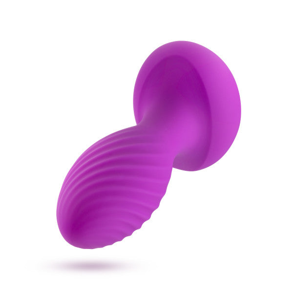 The Charm Vibrating Textured Silicone Butt Plug in Amethyst from Blush is a purple, ribbed sex toy with a curved shape and a flared base. Crafted from platinum cured silicone, its textured surface provides varied sensations, while the flared base ensures safety and ease of use. Designed for intimate, personal pleasure.