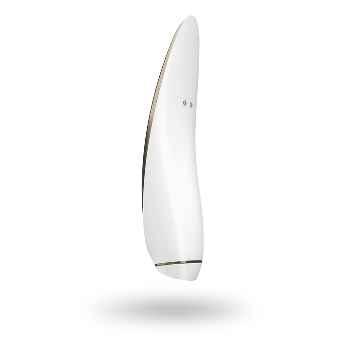 A sleek, modern teardrop-shaped device from Satisfyer, featuring a luxurious gold and black leather design with two small circular openings for clitoral stimulation, is displayed from the side against a black background. It includes an ergonomic handle for ease of use.