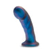 The Rebellion 5.75 Inch Silicone Beginner & Pegging Dildo by Blush showcases a shimmery blue hue with a stunning platinum-cured silicone composition, featuring a unique blue and purple swirl. Its curved, textured design is complemented by a wide base, allowing it to stand upright against a plain white background. Ideal for strap-on and pegging play.