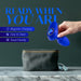 A hand is holding the Mystery Vibrating Textured Silicone Butt Plug in Sapphire by Blush, above a dark green toiletry bag on a marble surface. Text on the image reads "READY WHEN YOU ARE" and highlights features: Magnetic Charging, Easy to Clean, Travel Friendly.