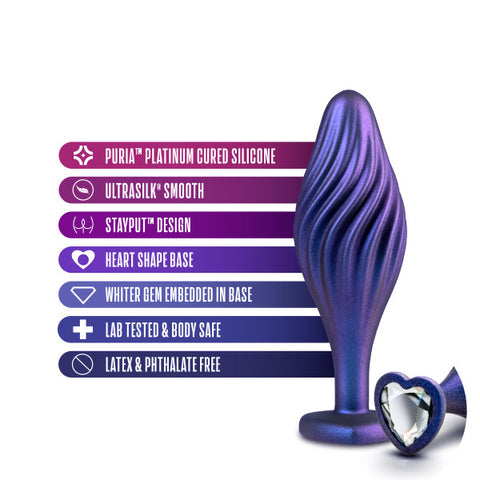 A stylized image showcasing a Matrix Swirl Bling Butt Plug with Sparkly Heart Base featuring unique qualities: puria® platinum cured silicone, ultrasilk® smooth texture, heartbeat design, with a white blush.